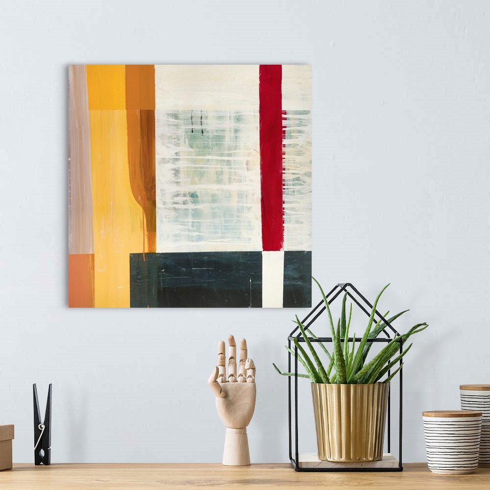 A bohemian room featuring Square abstract painting created using four sided shapes layered together.