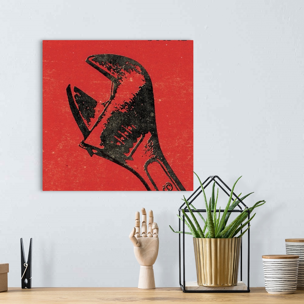 A bohemian room featuring Square art of a wrench on a red background.
