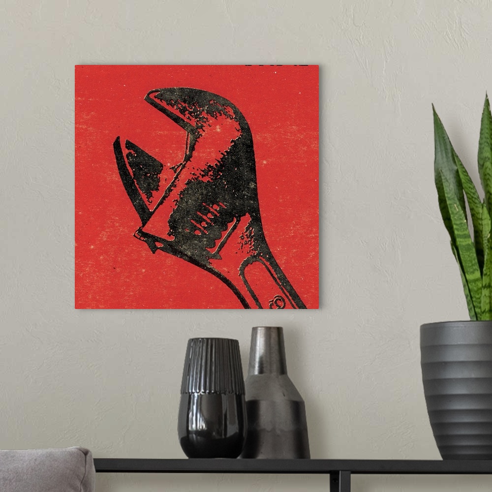 A modern room featuring Square art of a wrench on a red background.