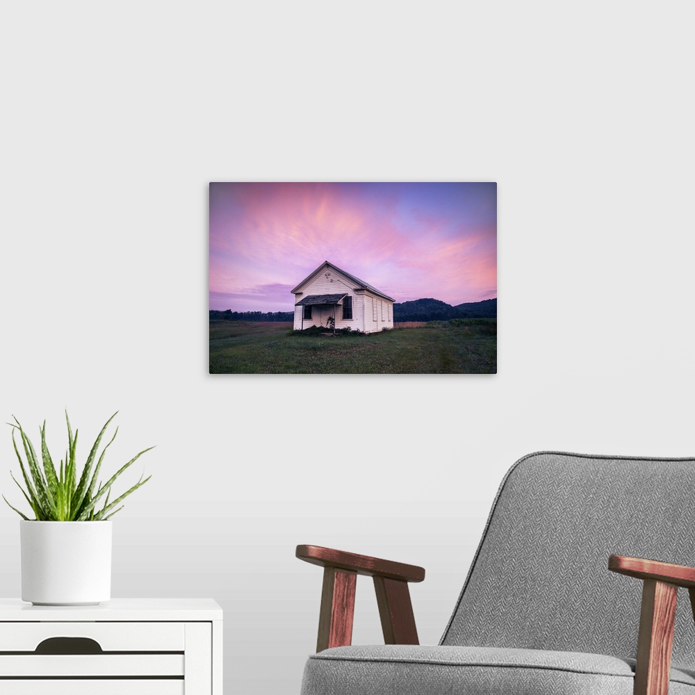 A modern room featuring Sunrise decorates the sky above an old church near Warren, Pennsylvania.