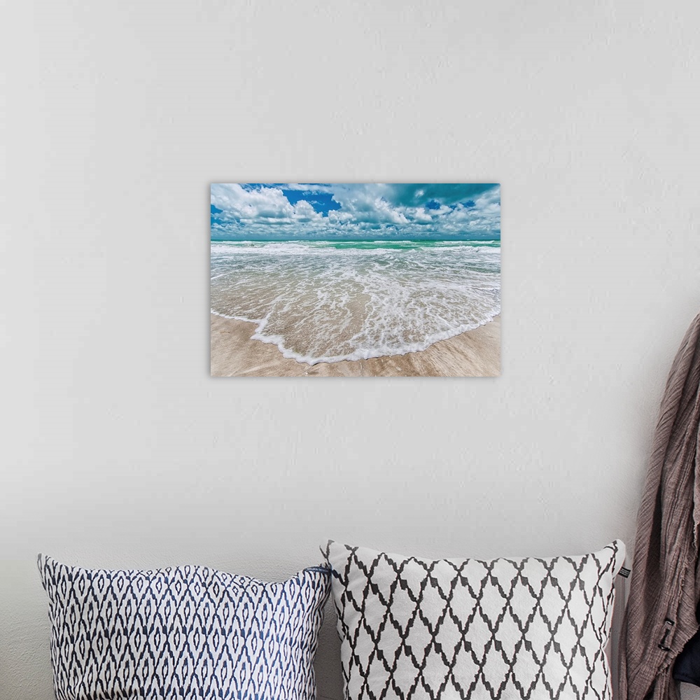 A bohemian room featuring Gentle waves wash onto a sandy beach in this summery photography