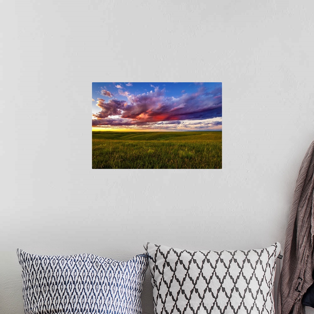 A bohemian room featuring The setting casts beautiful colors into the clouds over the plains near Pierre, South Dakota. Tim...