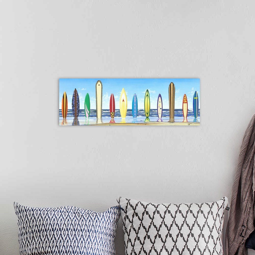 A bohemian room featuring Panoramic photograph of color surfboards standing in sand with the ocean in the background.