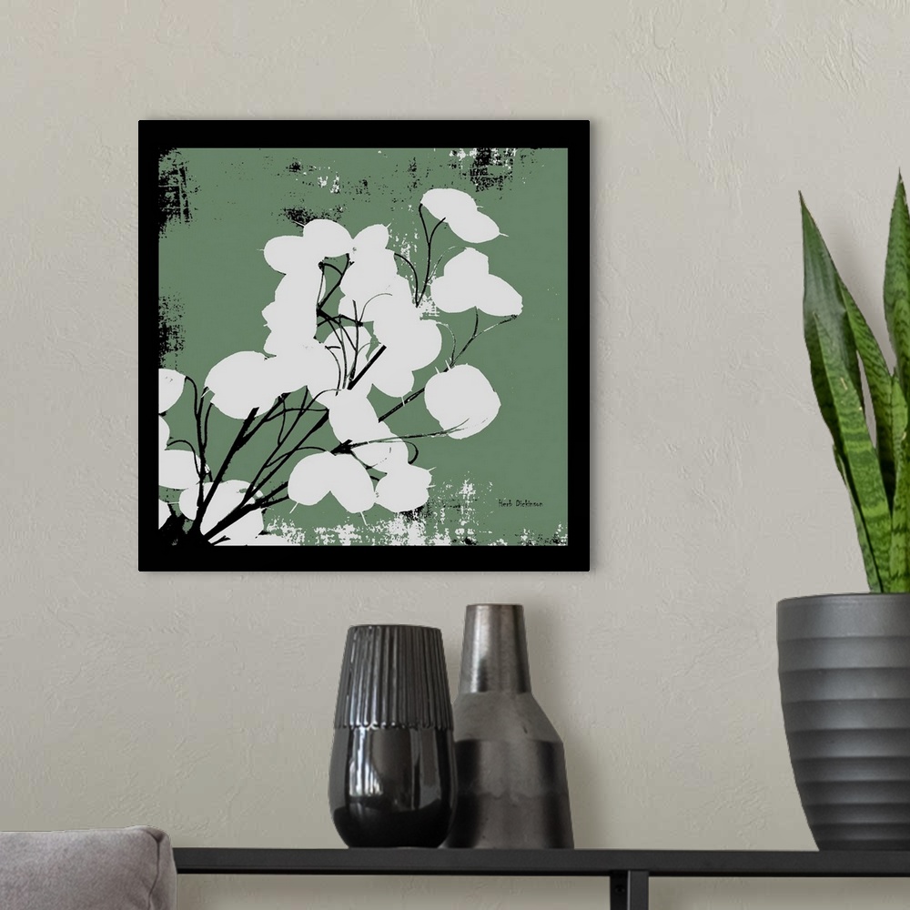 A modern room featuring Square silhouetted painting of a money plant in dusty green, black, and white with a black boarder.