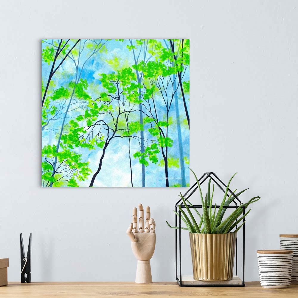 A bohemian room featuring Square painting with bright green tree tops on a cloudy blue background.