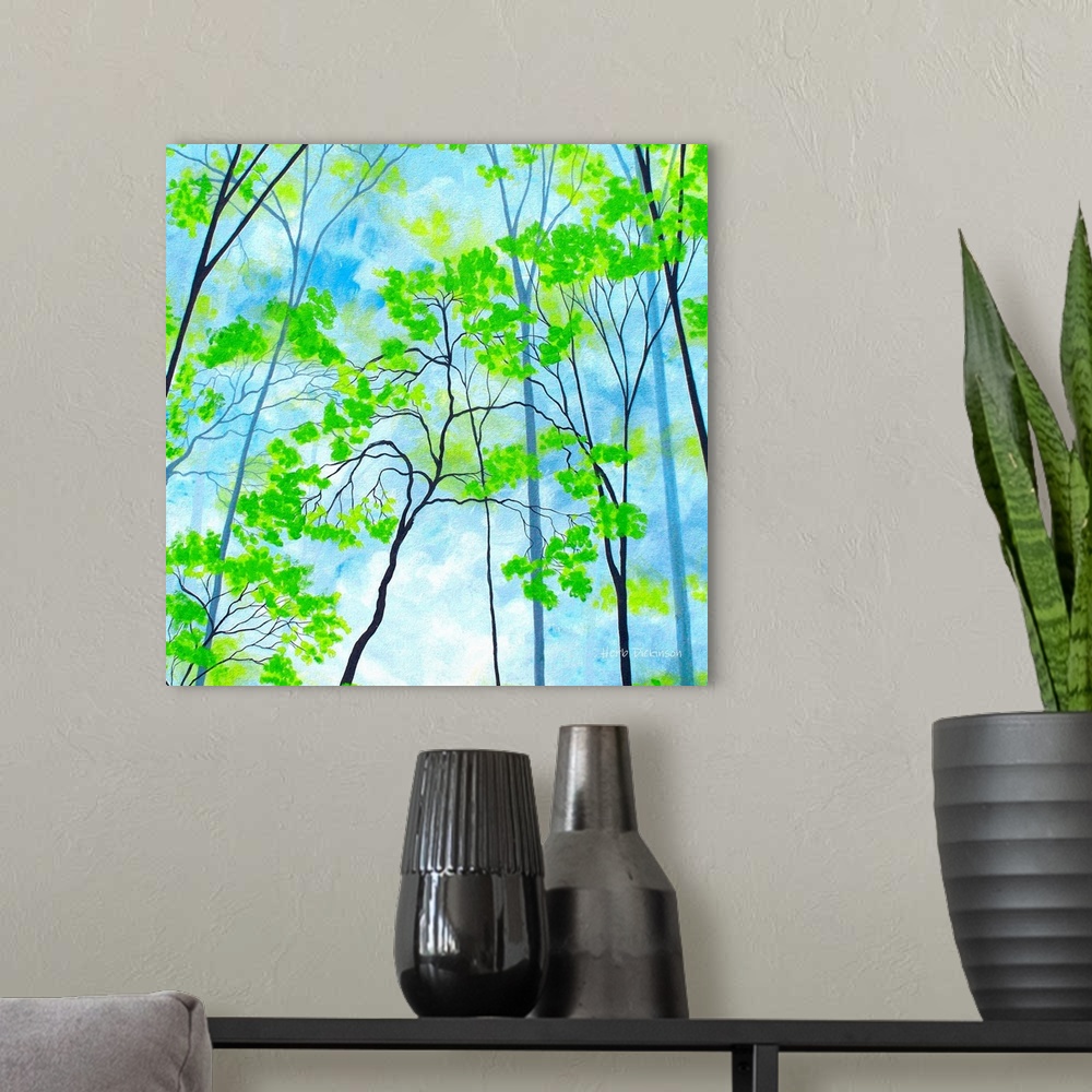 A modern room featuring Square painting with bright green tree tops on a cloudy blue background.