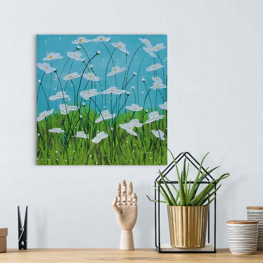 A bohemian room featuring Square painting of white flowers with long, thin stems in tall grass with a blue sky in the backg...