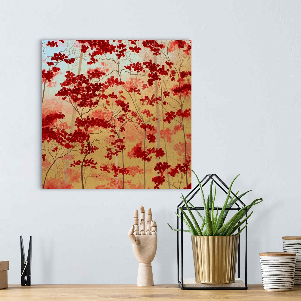 A bohemian room featuring Painting of bold red trees on a golden background.