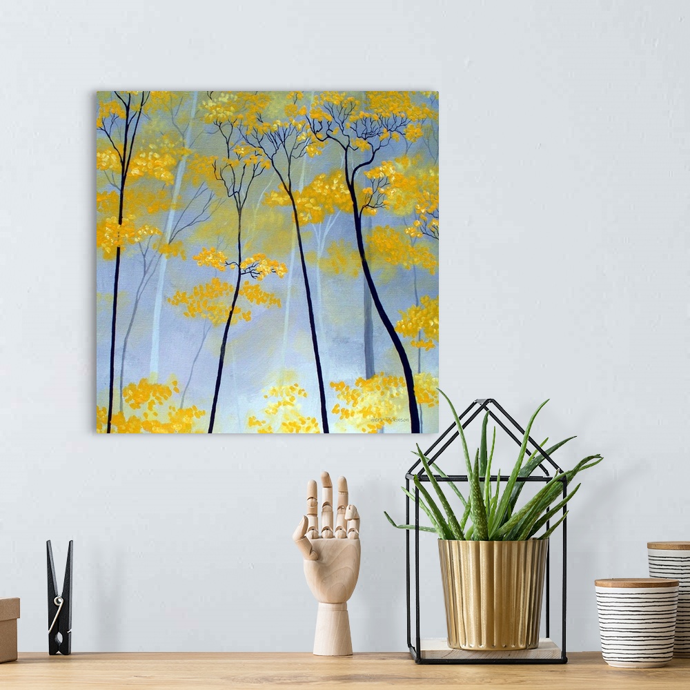 A bohemian room featuring Square painting of golden tree tops.