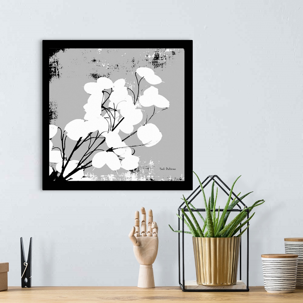 A bohemian room featuring Square silhouetted painting of a money plant in black, white, and gray.