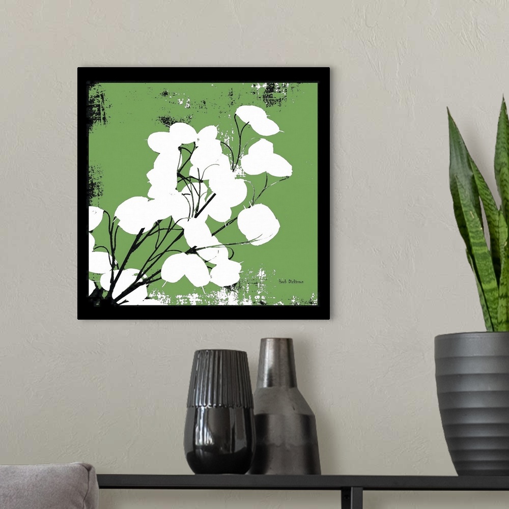 A modern room featuring Square silhouetted painting of a money plant in green, black, and white with a black boarder.