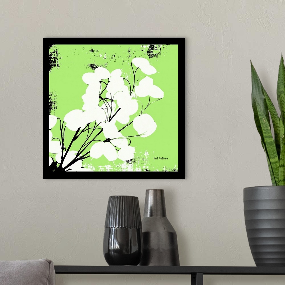 A modern room featuring Square silhouetted painting of a money plant in bright green, black, and white with a black boarder.