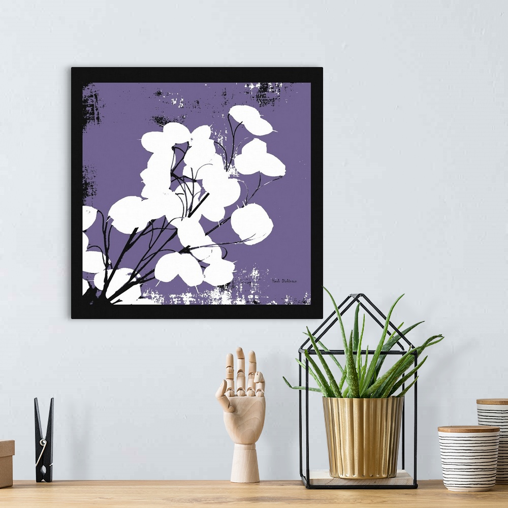 A bohemian room featuring Square silhouetted painting of a money plant in purple, black, and white, with a black boarder.