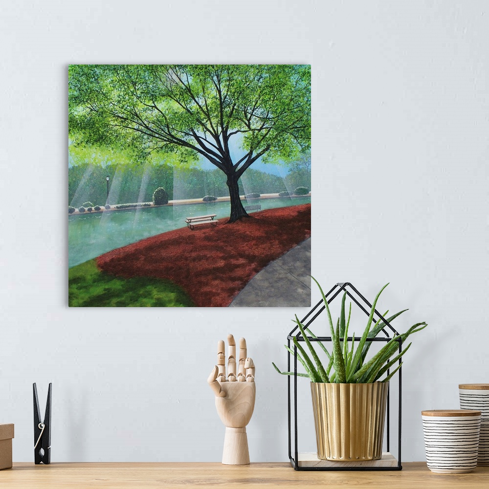 A bohemian room featuring Freedom Park landscape painting on a square canvas with light beaming onto the water behind the t...