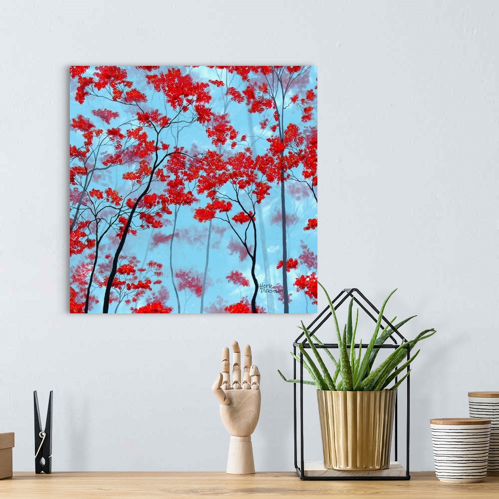 A bohemian room featuring Square painting of tree tops with red leaves on a light blue background.