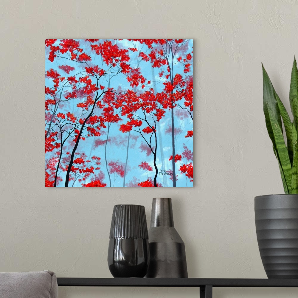 A modern room featuring Square painting of tree tops with red leaves on a light blue background.
