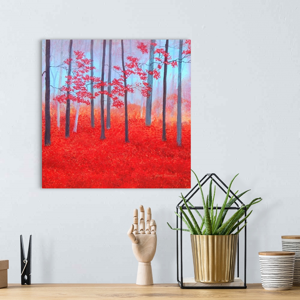 A bohemian room featuring Impressionist painting of a red Autumn forest with leaves covering the ground.