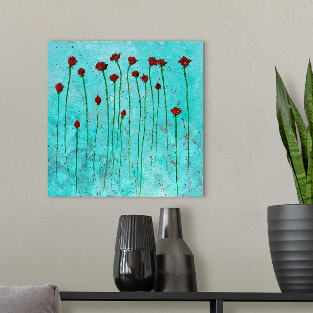 A modern room featuring Square painting of red roses with long green stems on an aqua background with red paint splatter.
