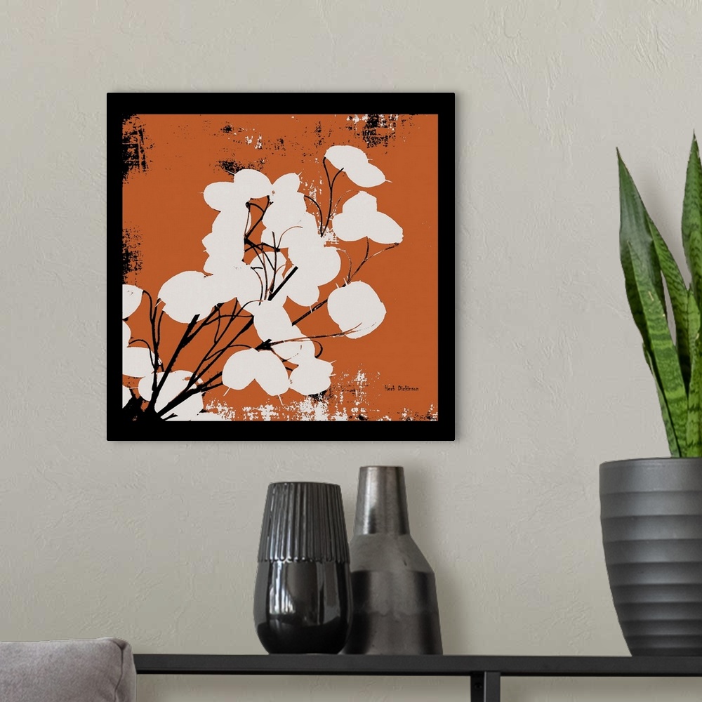 A modern room featuring Square silhouetted painting of a money plant in orange, black, and white with a black boarder.