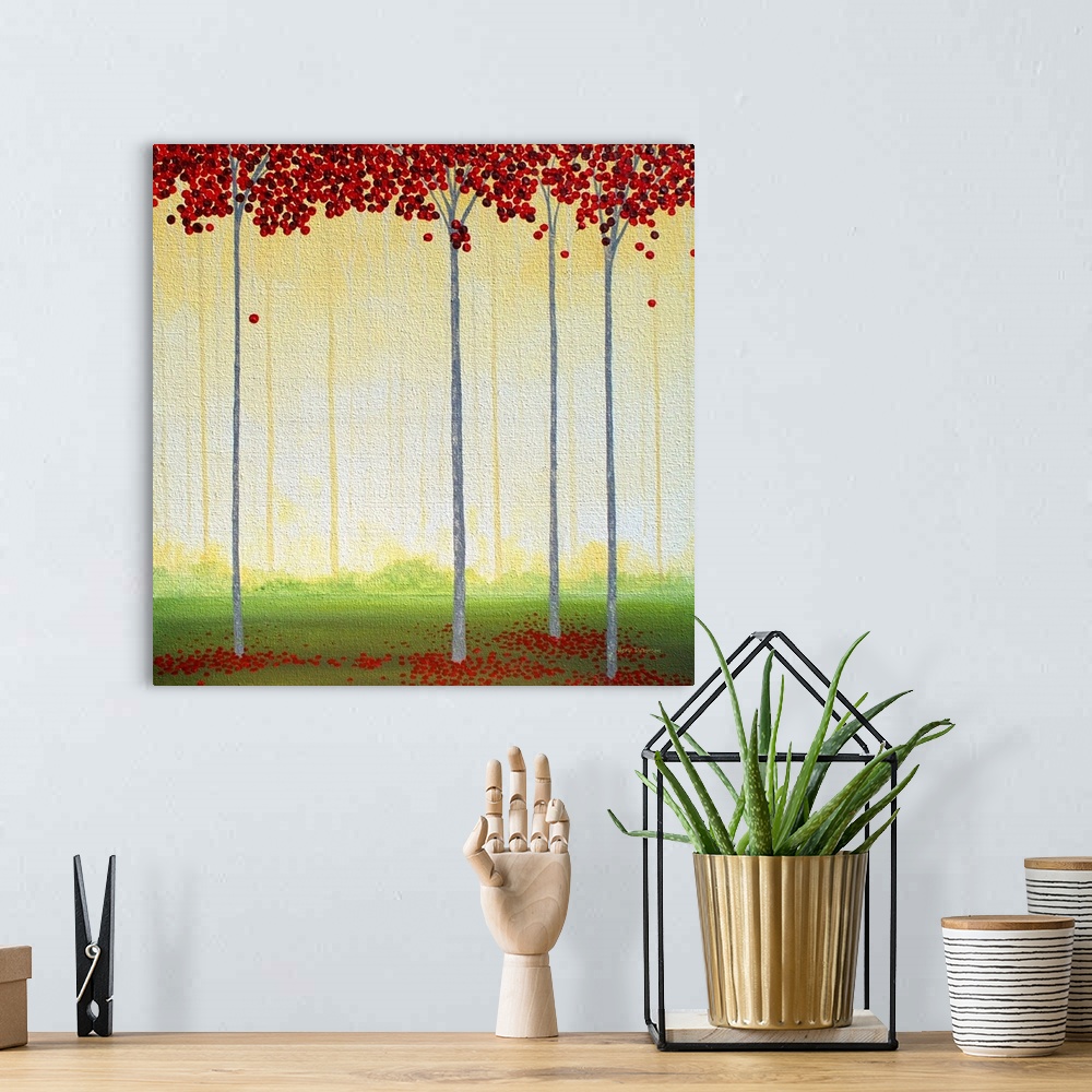A bohemian room featuring Square painting of tall, thin trees with circular red leaves in a golden lit forest.