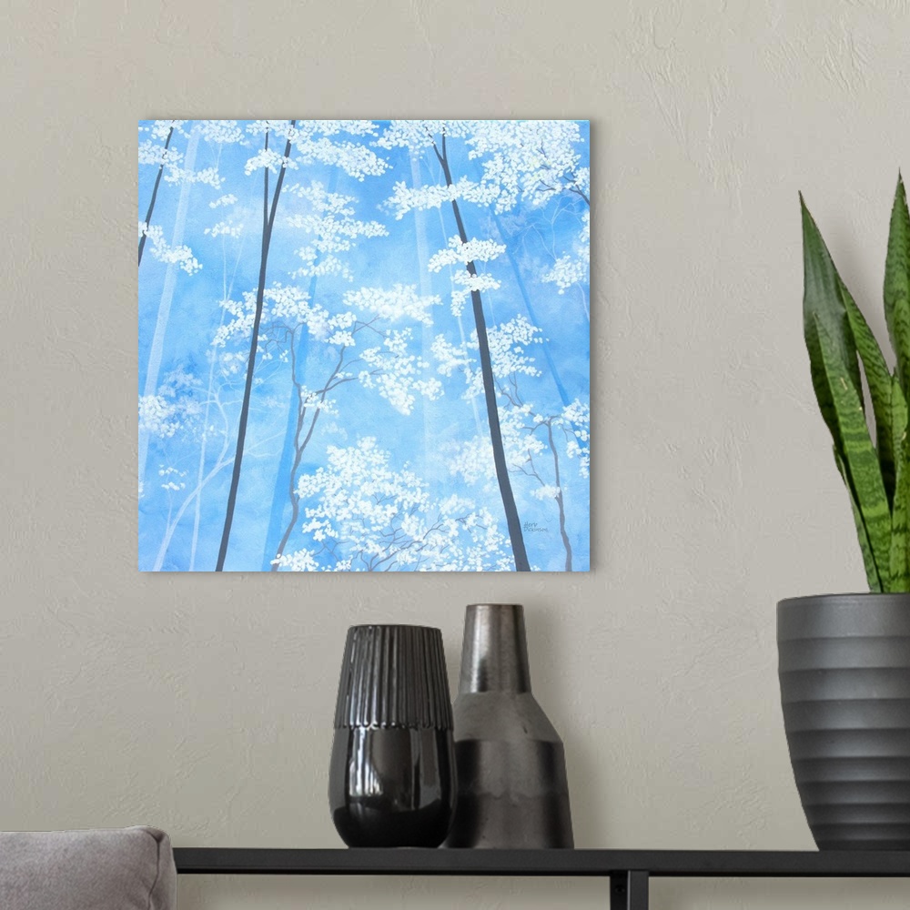 A modern room featuring Impressionist painting looking up at white blossomed tree tops with a sky blue background.