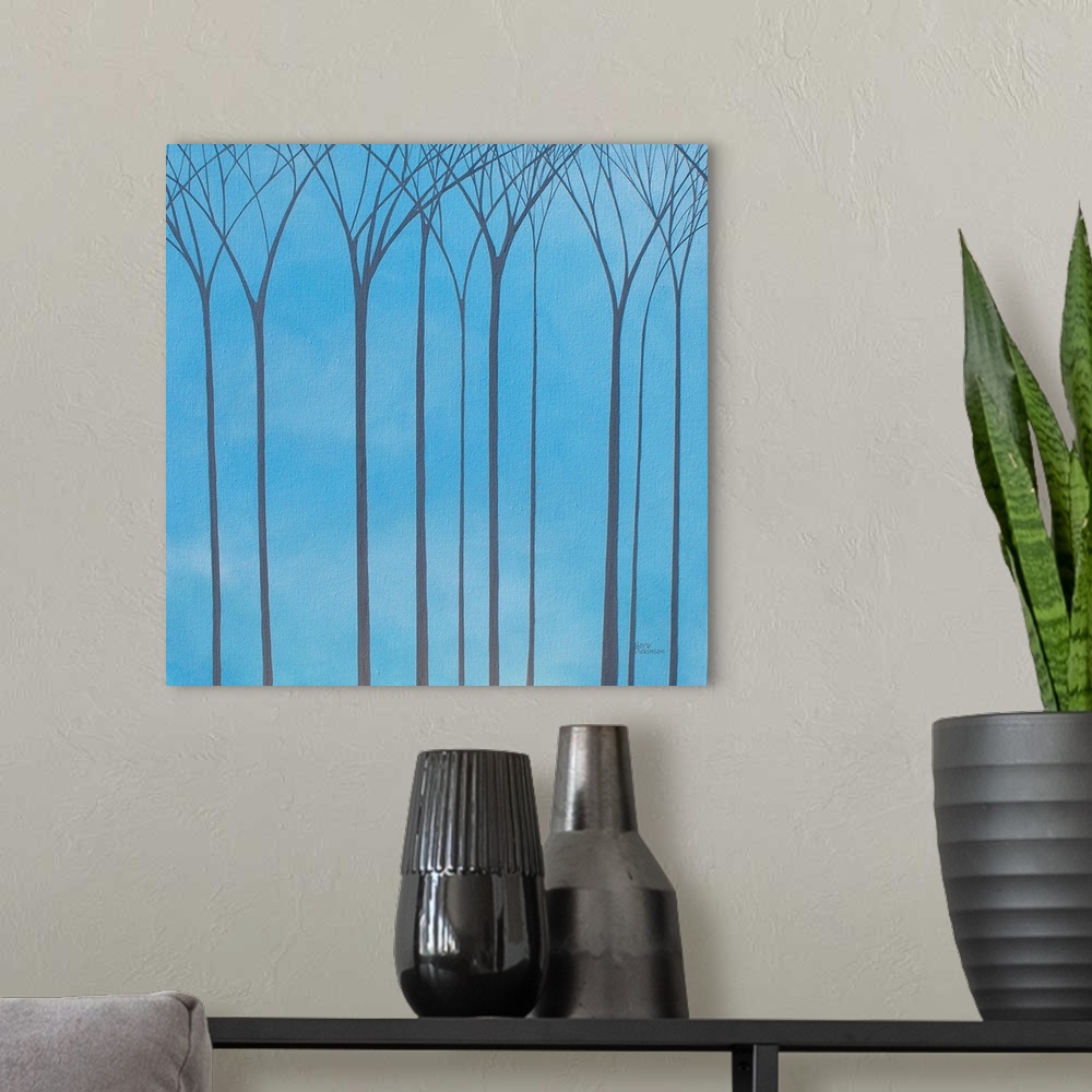 A modern room featuring Tall, bare, gray, Winter trees on a blue background.