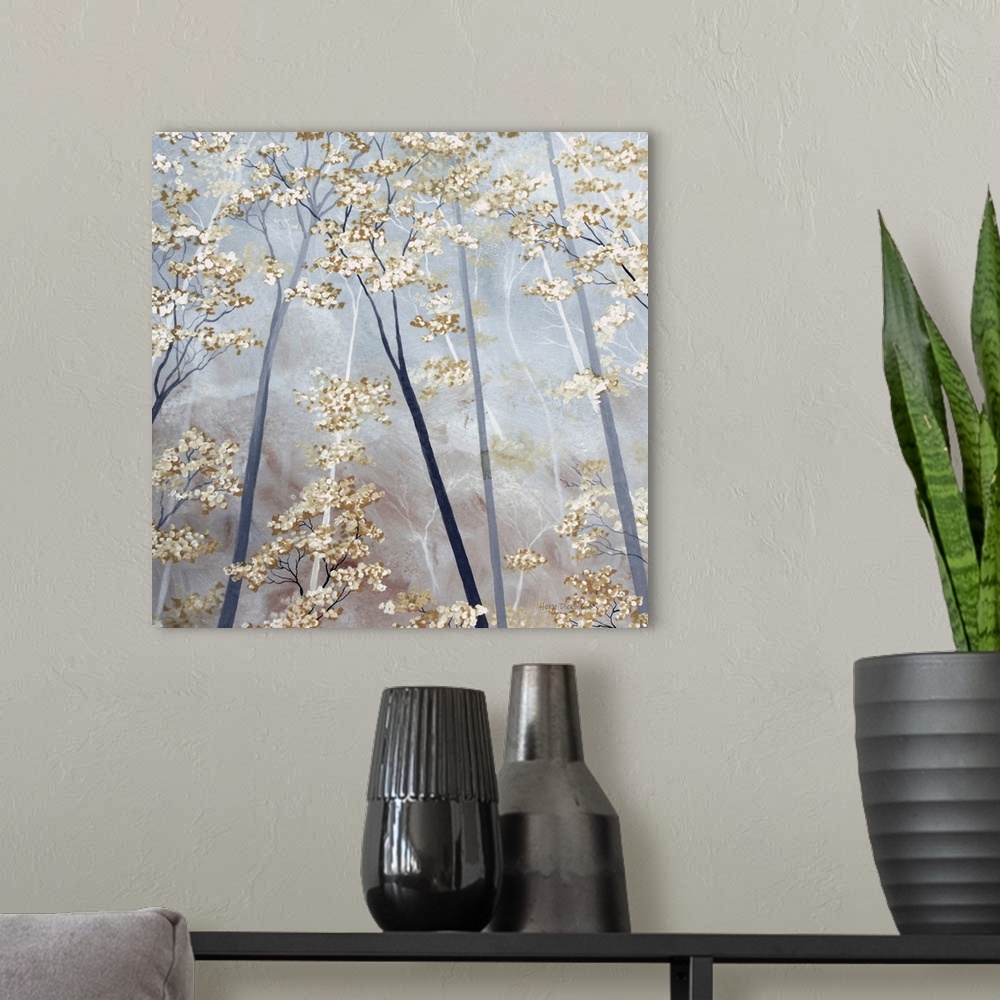 A modern room featuring Square painting of tree tops with taupe and white blossoms on a gray background.