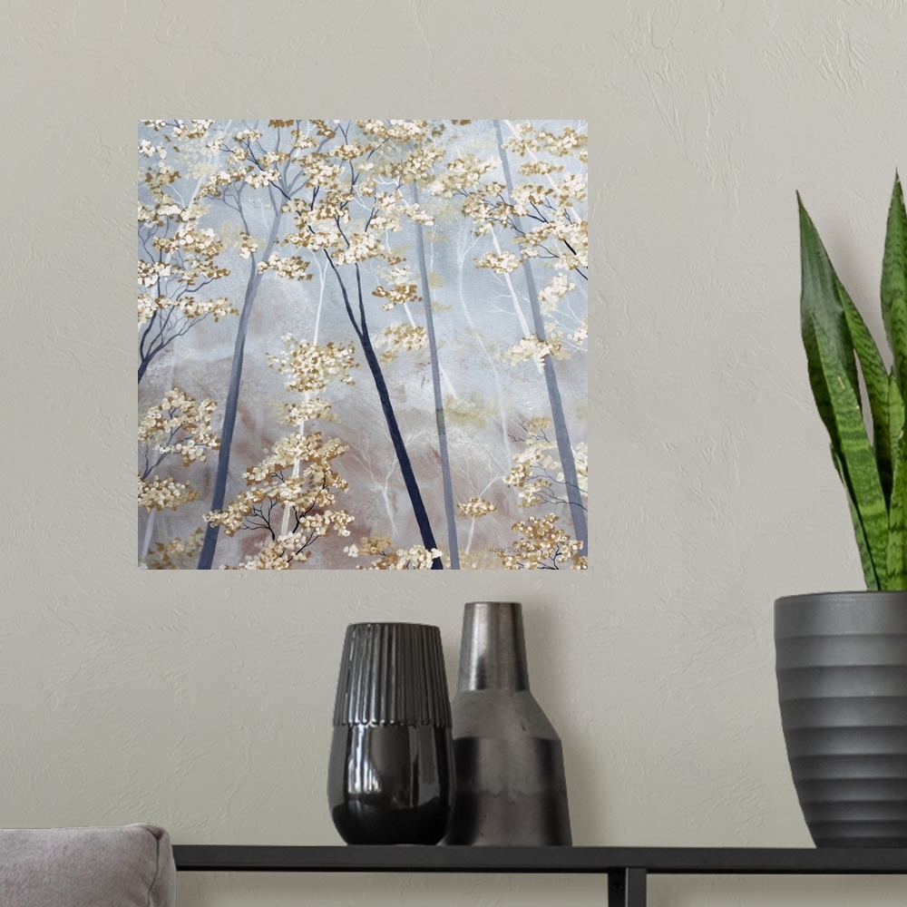 A modern room featuring Square painting of tree tops with taupe and white blossoms on a gray background.