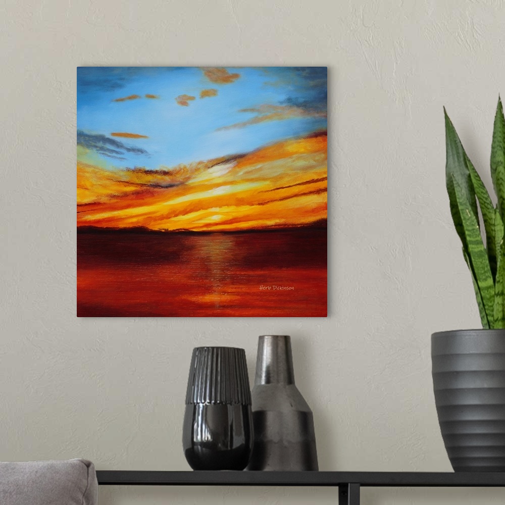 A modern room featuring Abstract landscape painting with a bold red, orange, and yellow sunset.
