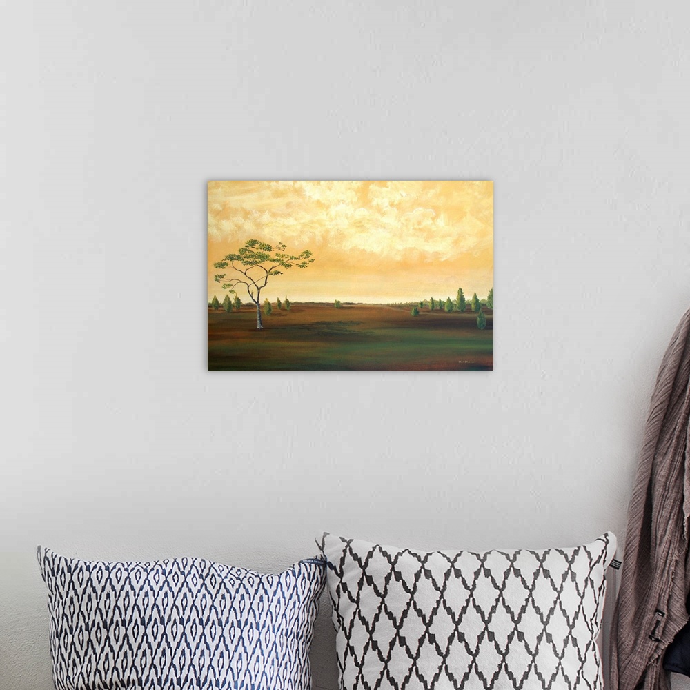 A bohemian room featuring Contemporary landscape painting of a countryside with a few trees and a golden sky.