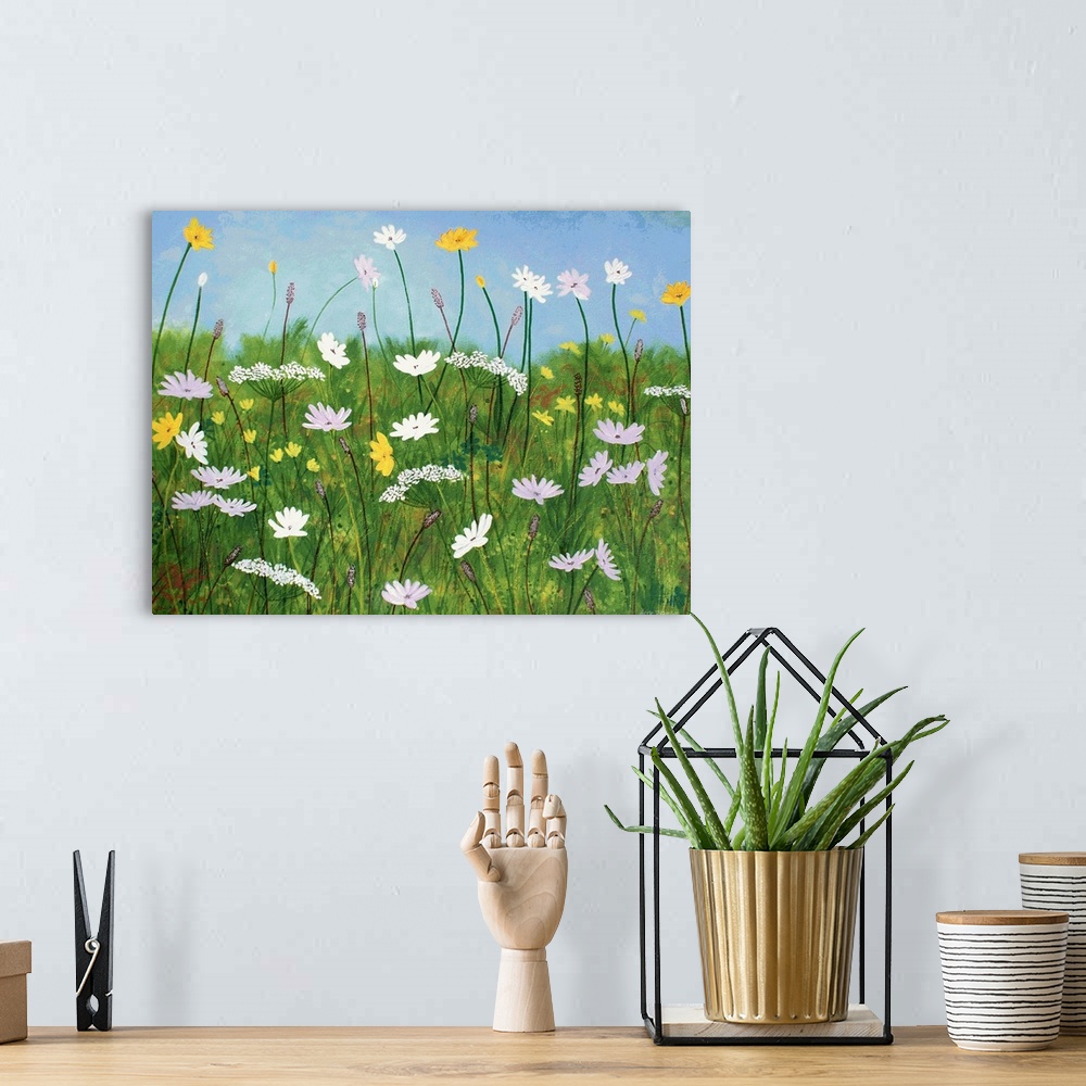 A bohemian room featuring Contemporary painting of wildflowers with a grassy green background and a clear light blue sky.