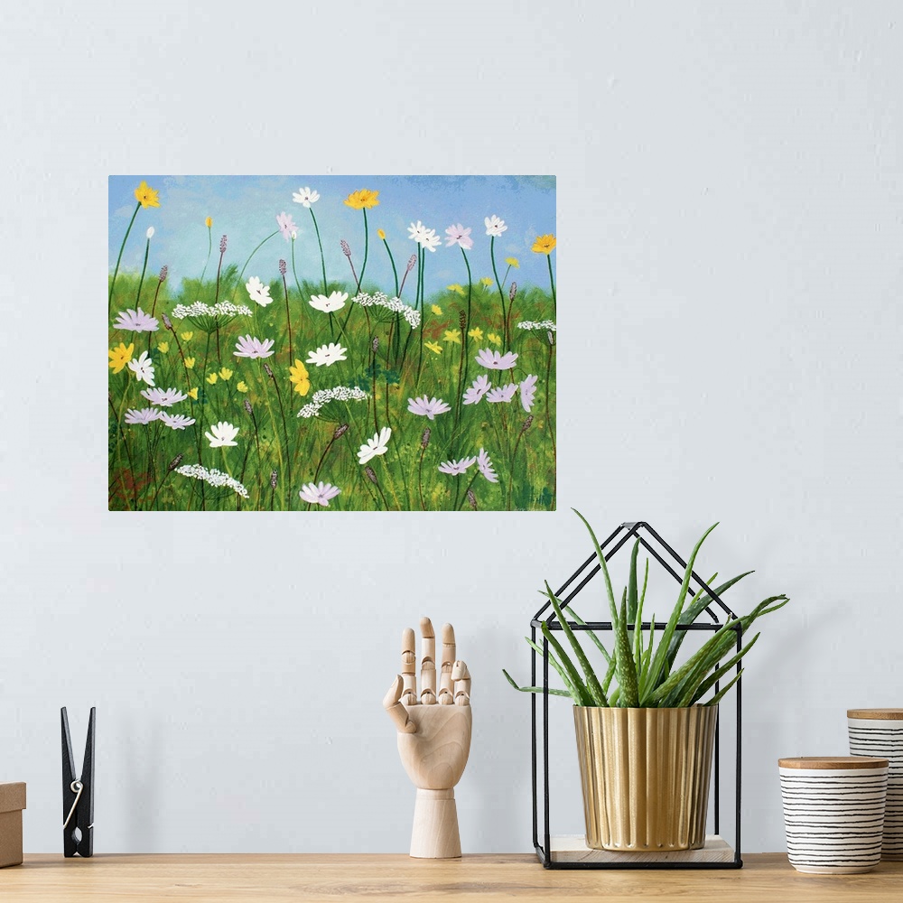 A bohemian room featuring Contemporary painting of wildflowers with a grassy green background and a clear light blue sky.