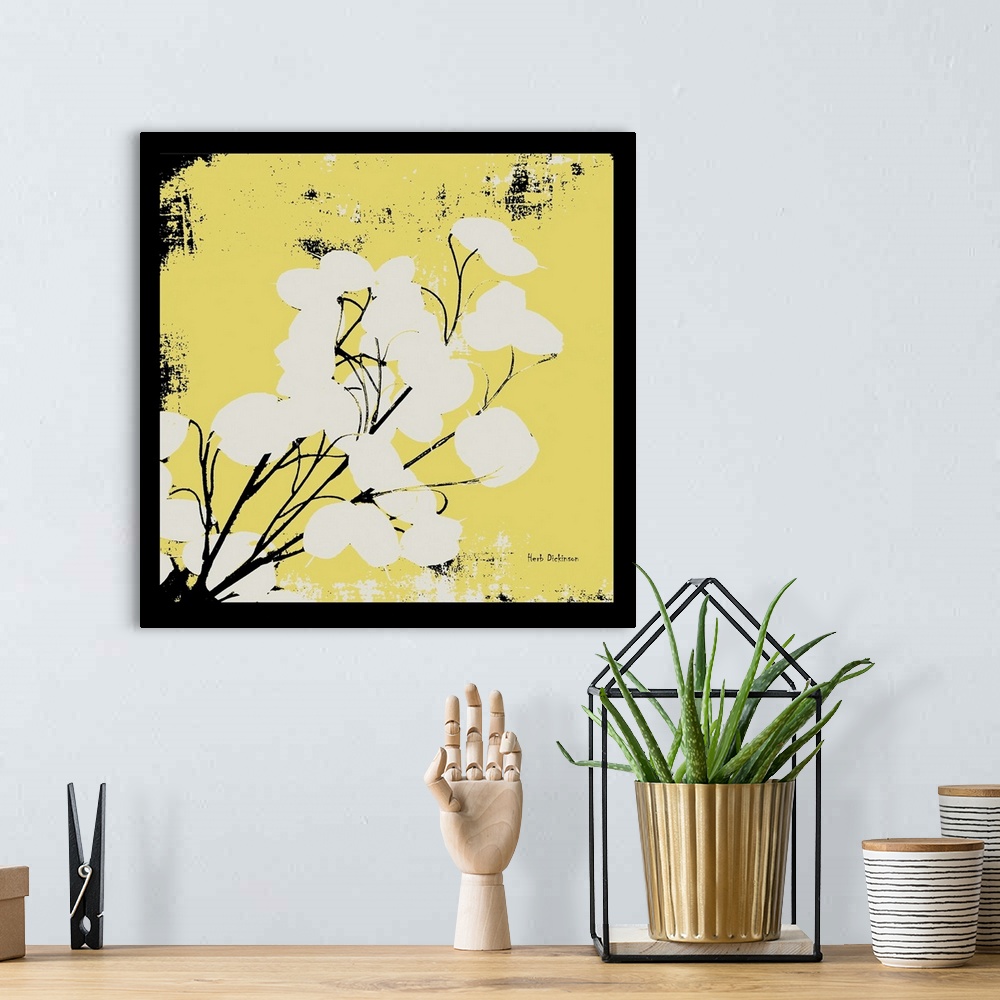A bohemian room featuring Square silhouetted painting of a money plant in pale yellow, black, and white with a black boarder.