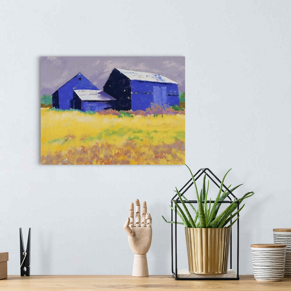 A bohemian room featuring Contemporary painting of a blue barn and farm house in a yellow field.