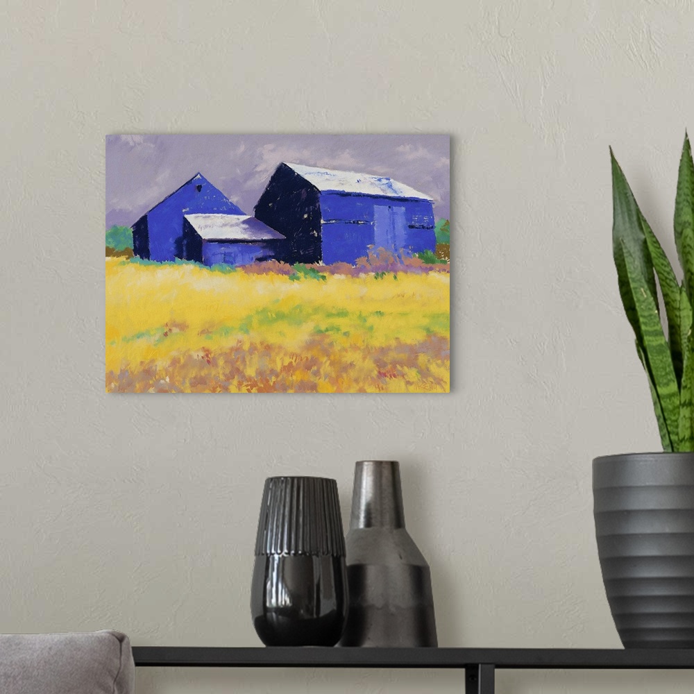 A modern room featuring Contemporary painting of a blue barn and farm house in a yellow field.