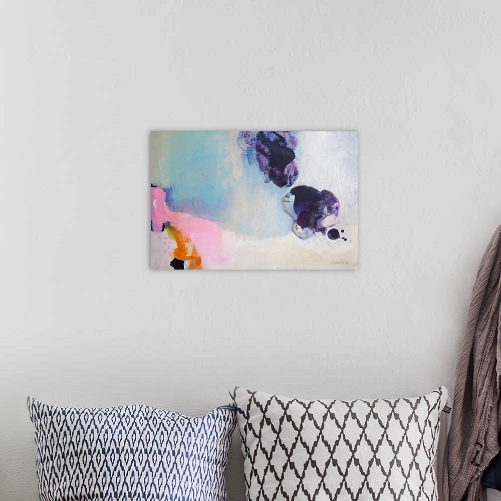 A bohemian room featuring A horizontal abstract painting with colors of purple, pink and blue.