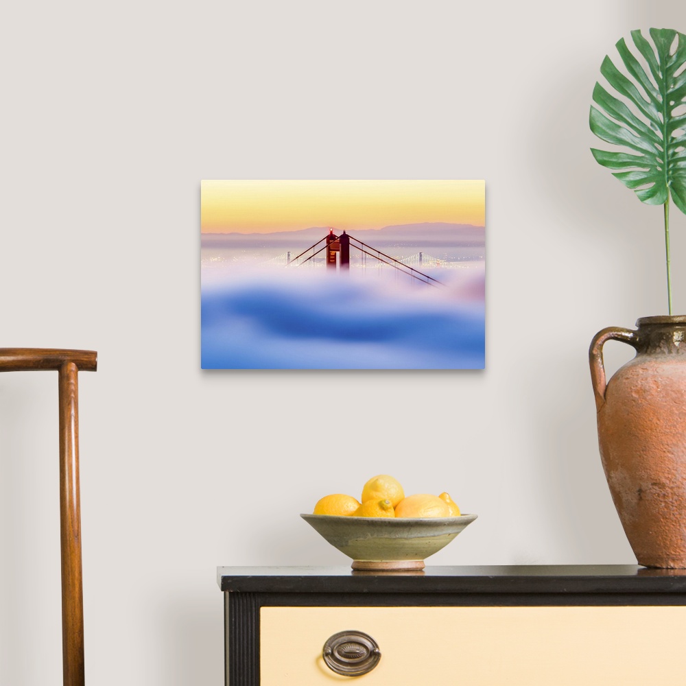A traditional room featuring A dynamic photograph of the golden gate bridge just barely making it above a thick blanket of clo...