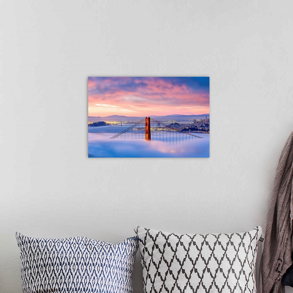 A bohemian room featuring Aerial view of the Golden Gate Bridge surrounded by fog.