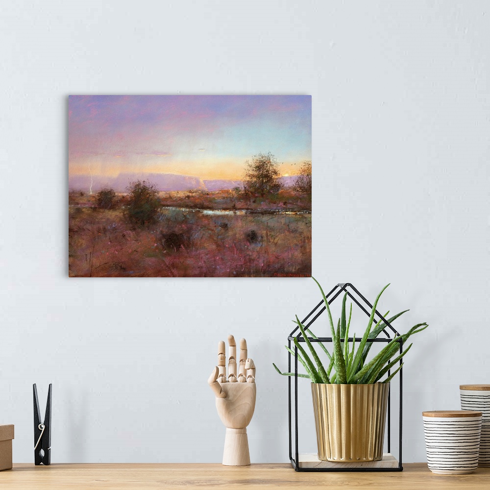 A bohemian room featuring A contemporary painting of a southwestern landscape under a purple sky.