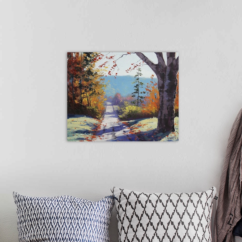 A bohemian room featuring Contemporary painting of an idyllic countryside landscape, with a road cutting through autumn fol...