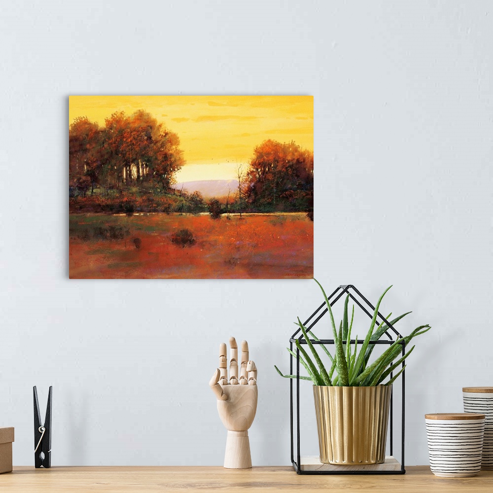 A bohemian room featuring A contemporary painting of a southwestern landscape under an orange sky.