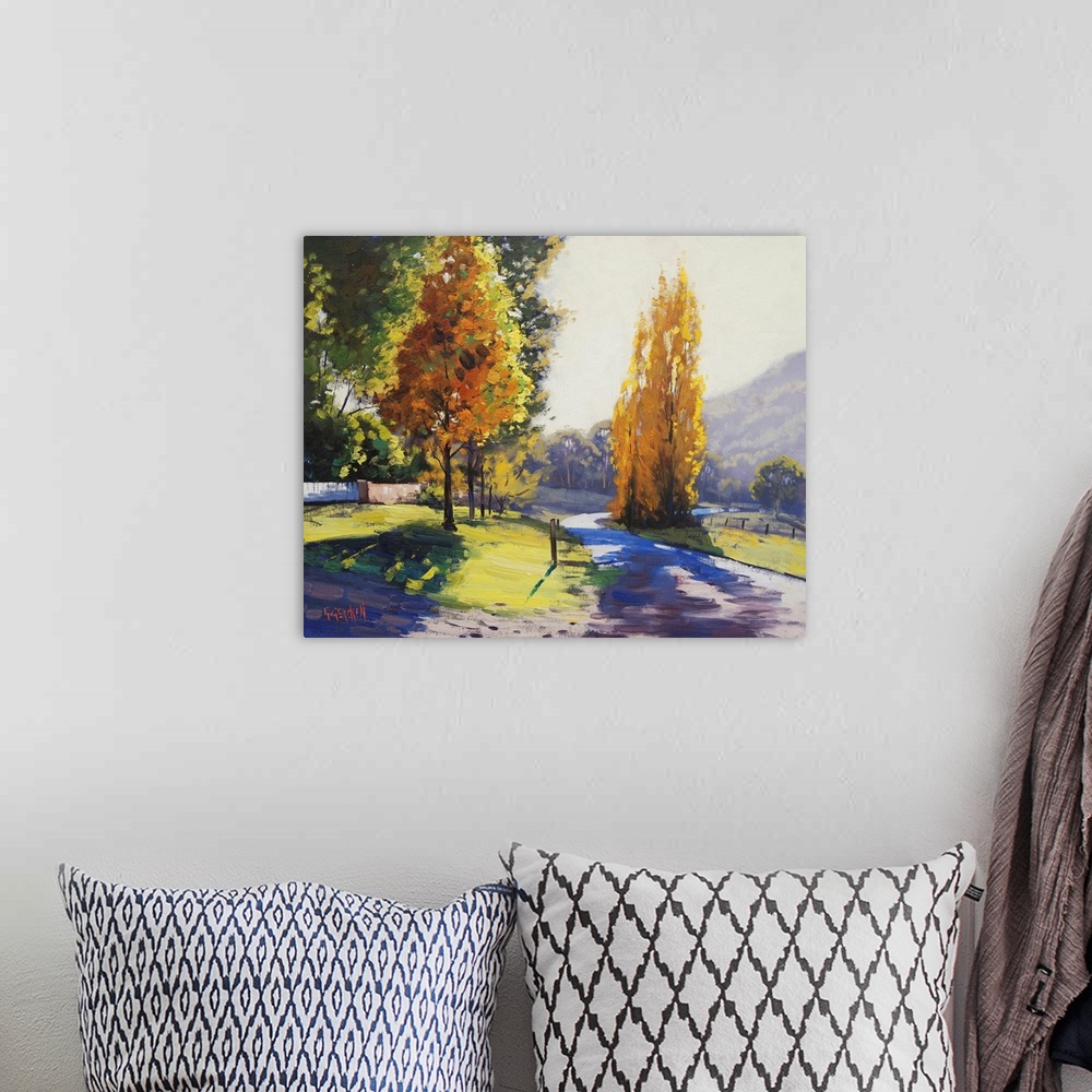 A bohemian room featuring Painting of a landscape in early autumn.