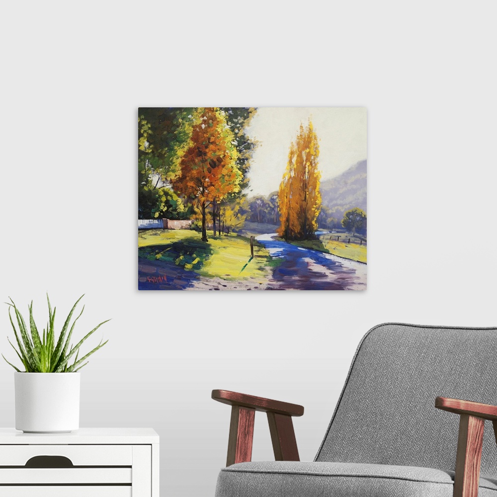 A modern room featuring Painting of a landscape in early autumn.