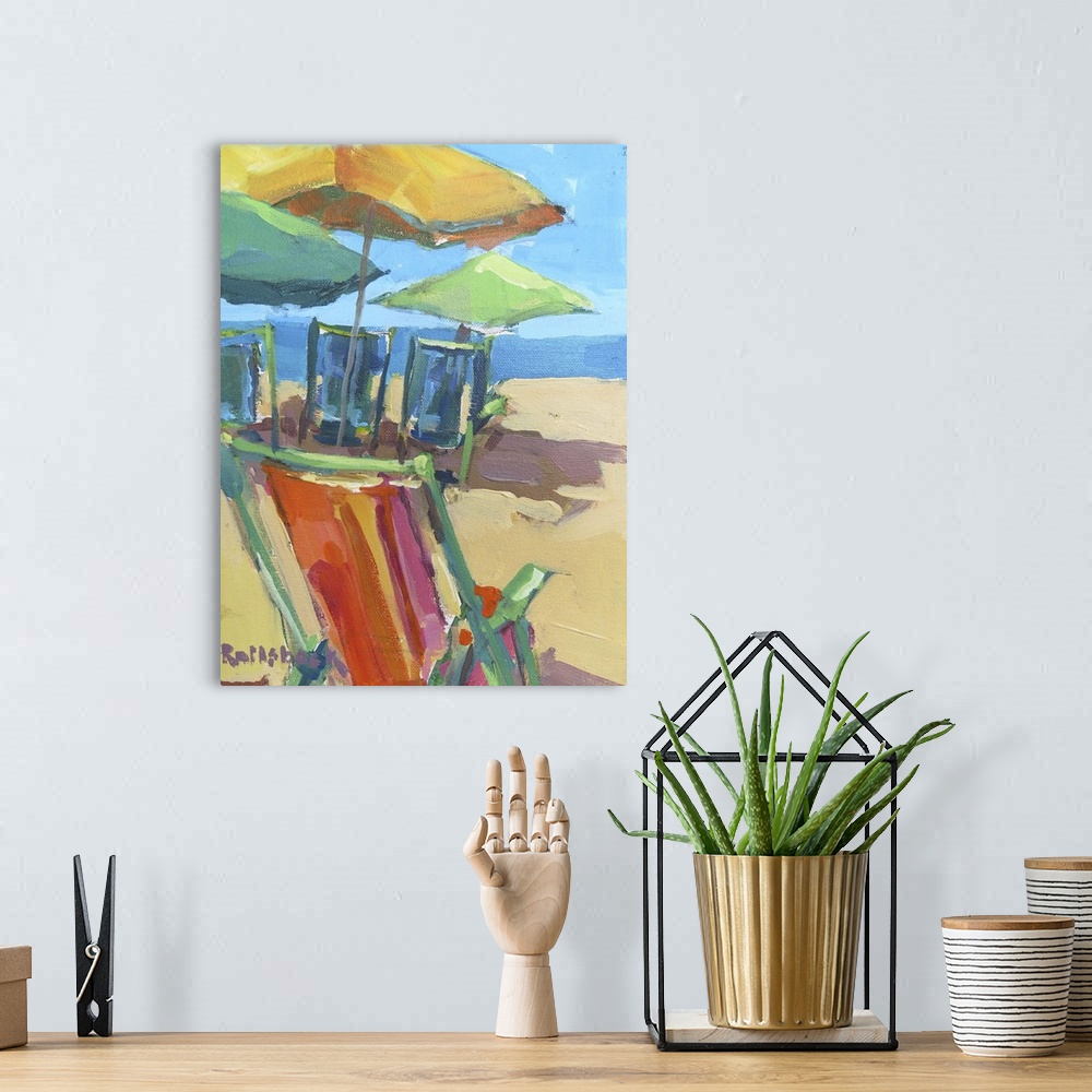 A bohemian room featuring A coastal themed painting of colorful chairs sitting on a beach.