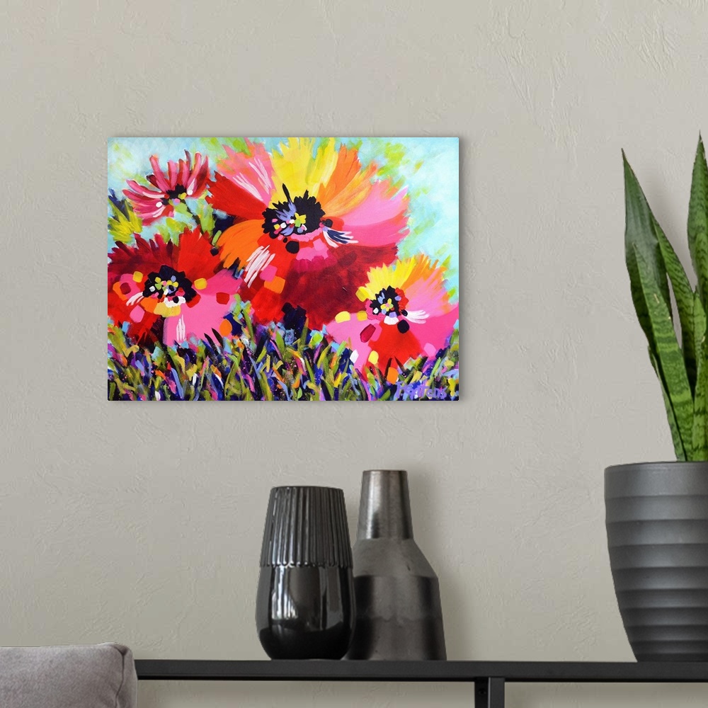 A modern room featuring A horizontal abstract painting of bright poppies in colors of yellow, red and pink.