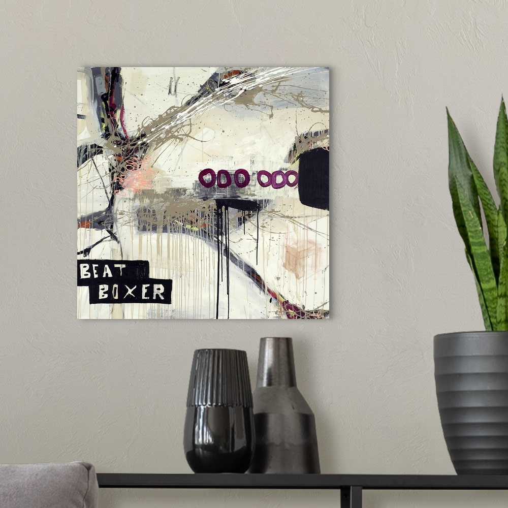 A modern room featuring Square contemporary collage with text and dripped paint with circles.