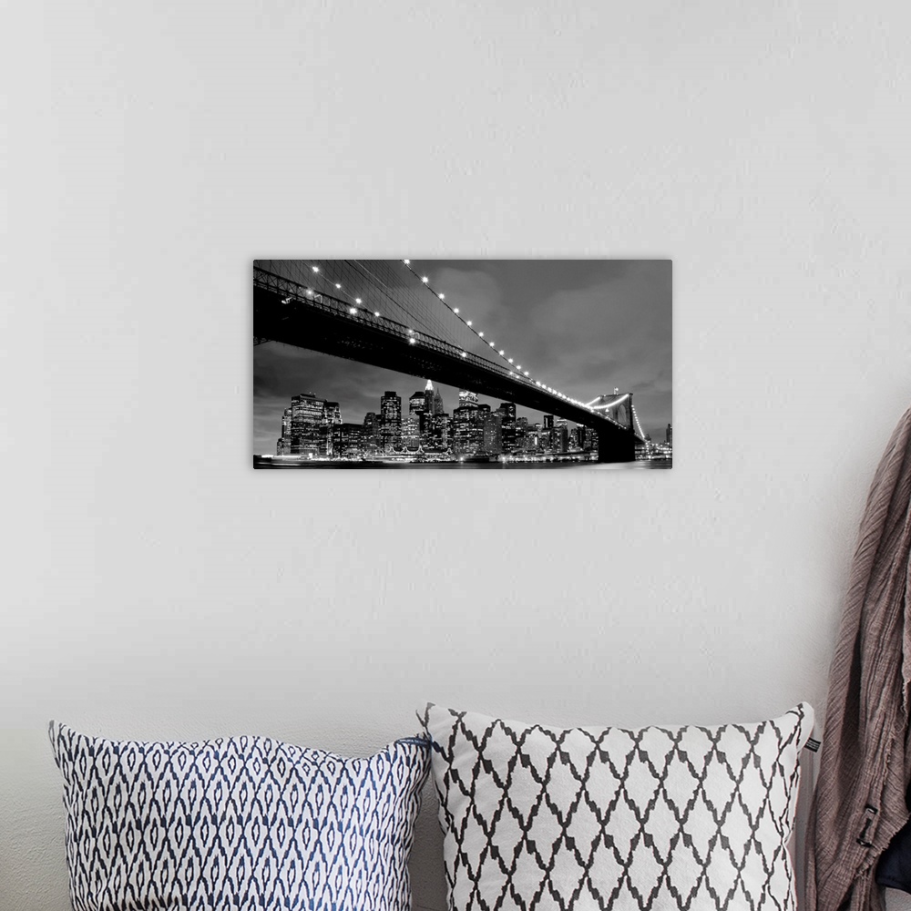 A bohemian room featuring Black and white panoramic of the Brooklyn Bridge with New York City in the background.