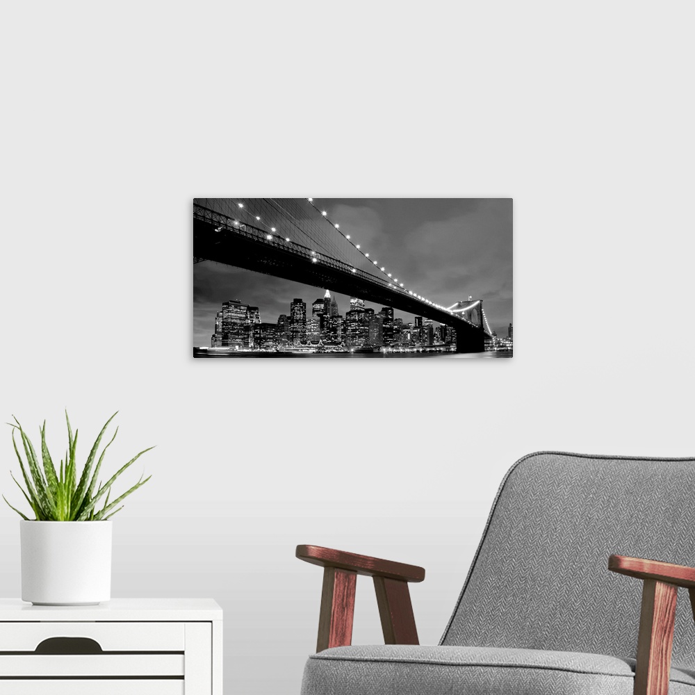 A modern room featuring Black and white panoramic of the Brooklyn Bridge with New York City in the background.