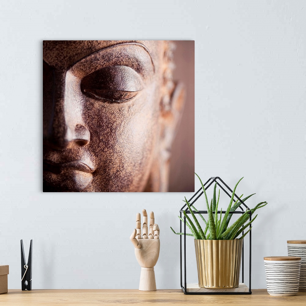 A bohemian room featuring Square close up photograph of a Buddha statue.