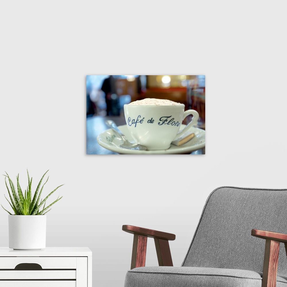 A modern room featuring A close up photograph of a cup of coffee from Cafe de Flore in Paris.
